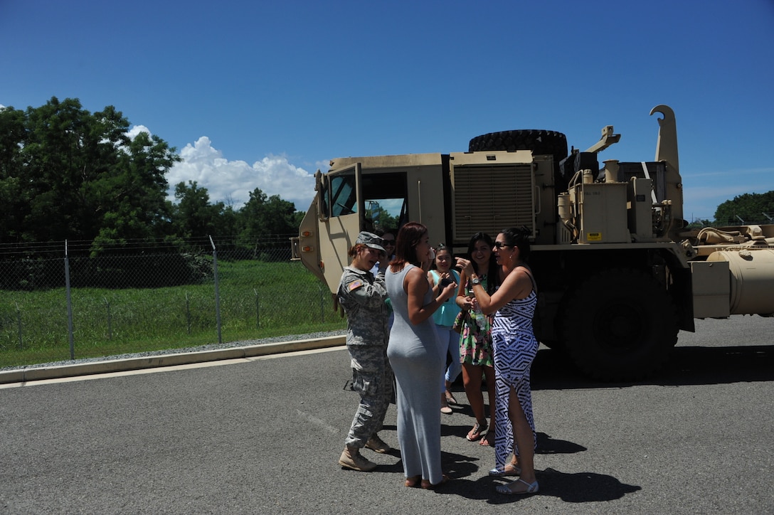 Spec. Valerie Velez and her family share an emotional moment after the 246th Quartermaster Co. (MA) farewell ceremony at the Army Reserve Center at Mayaguez, PR.