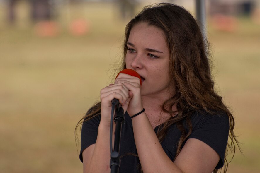 Emma Everett, a 14 year-old singer from Cabot, Ark., entertains visitors to the 2016 Arkansas Military Expo at Little Rock Air Force Base, Ark., Sept. 17, 2016. Emma is part of the five-member band “Elevation,” and has been singing with the band since May 2016. The performance at the Little Rock AFB, was the band’s first gig. (U.S. Air Force photo by Master Sgt. Jeff Walston/Released)