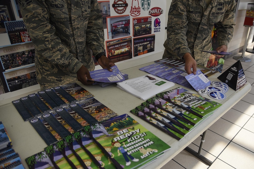 Airman 1st Class Donnie Hamilton, left, and Staff Sgt. Shaun Ouellette, 11th Civil Engineering Squadron readiness and emergency managers, clean up their educational booth in the Base Exchange at Joint Base Andrews, Md., Sept. 23, 2016. Hamilton and Ouellette were at the BX for National Preparedness Month to inform JBA members on techniques to use in a disaster. (U.S. Air Force photo by Airman 1st Class Valentina Lopez)