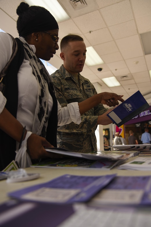Staff Sgt. Shaun Ouellette, 11th Civil Engineering Squadron readiness and emergency manager, shares his survival knowledge with Rachel Thomas, an installation member, in the Base Exchange at Joint Base Andrews, Md., Sept. 23, 2016. Ouellette set up an educational booth for National Preparedness Month to inform JBA members on ways to be prepared for natural disasters, active shooters, and a terrorist attack. (U.S. Air Force photo by Airman 1st Class Valentina Lopez)