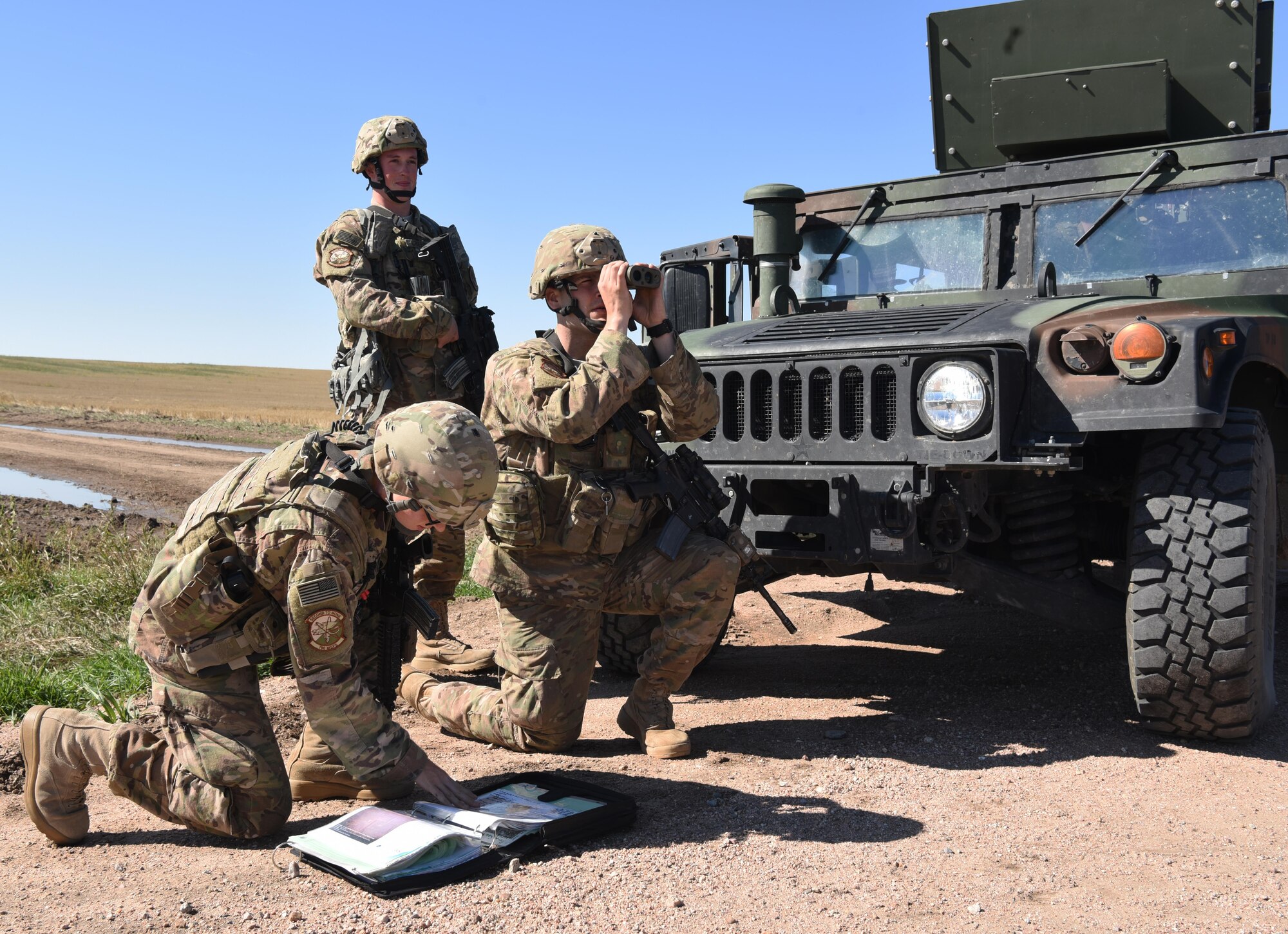 Airmen with the 790th Missile Security Forces Squadron security support team response force look over their tactical assault response plan and monitor avenues of approach at a 90th Missile Wing launch facility Sept. 16, 2016. The security support team had to remain within a five-minute response time to the affected site.