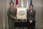 Gen. Lori Robinson, Commander of NORAD and USNORTHCOM, accepts the original NORAD emblem artwork from Ms. Mona Rowe, daughter of the late Mr. Paul Jaffe, designer of the original emblem at the North American Aerospace Defense Command and U.S. Northern Command Headquarters in Colorado Springs, Colo., Sept. 23, 2016.  In honor of her father, Rowe donated his artwork to the commands.  "My father's work resides with family," Rowe said.