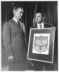 Mr. Paul Jaffe (right), the designer of the original North American Aerospace Defense Command emblem, shows his artwork to Gen. Earle E. Partridge, first commander of NORAD, in approximately 1957.  NORAD was formally established in 1958.  Jaffe’s daughter, Ms. Mona Rowe, donated her late father’s original artwork of the emblem to the command at the NORAD and U.S. Northern Command Headquarters in Colorado Springs, Colo., Sept. 23, 2016.  (Jaffe Family Courtesy Photo)