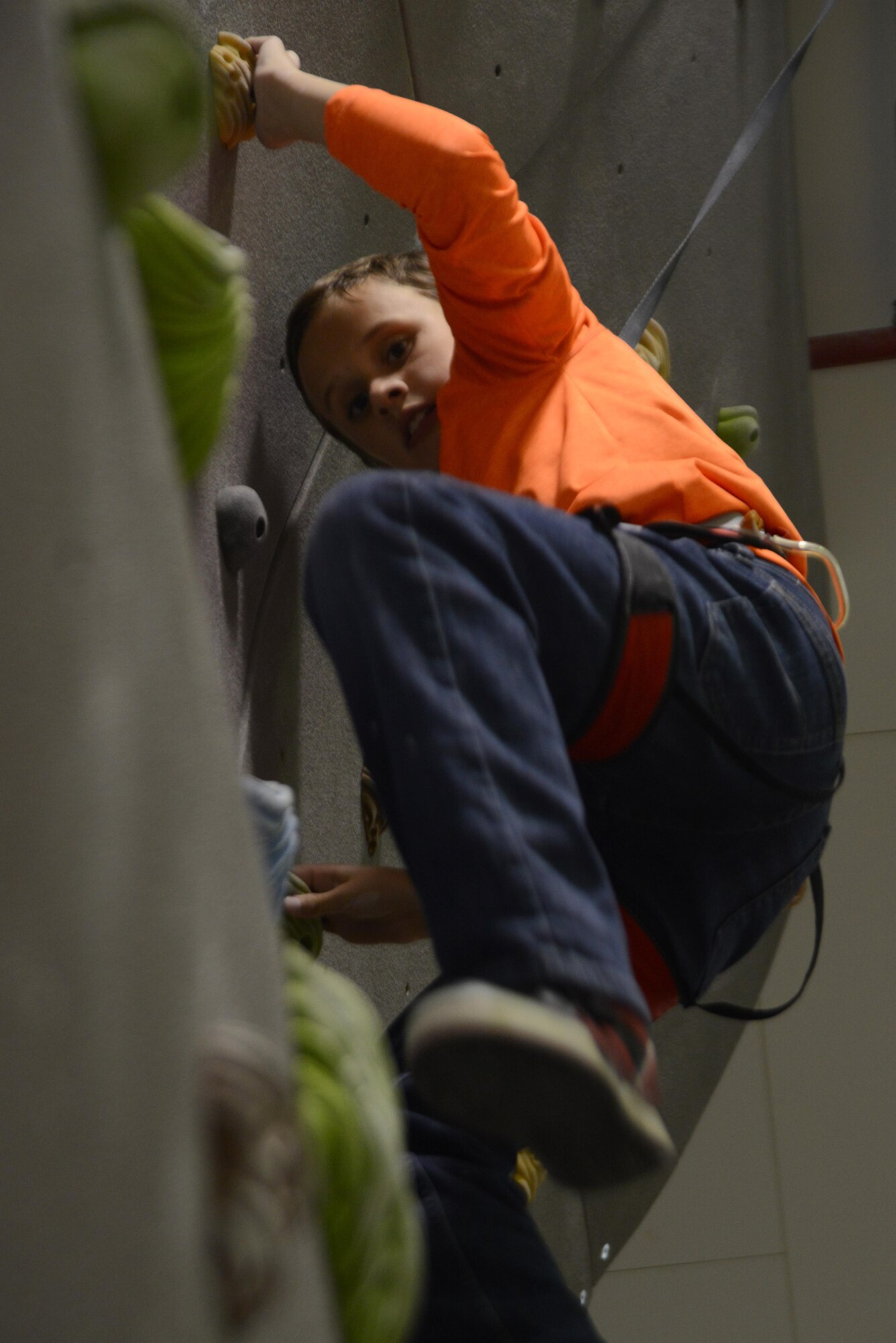 Lucas, 10, son of Tech. Sgt. Stacey Varner with the 673d Aerospace Medical Squadron, climbs an indoor rock wall during the Worldwide Day of Play at the Kennecott Youth Center at Joint Base Elmendorf-Richardson, Alaska, Sept. 21, 2016. The Worldwide Day of Play is an annual event that encourages kids and parents to go outside and play instead of sitting indoors and watching television. Due to inclement weather, the Kennecott Youth Center provided several games and stations like the cupcake walk, indoor rock climbing, batting cage, pitching mound and more.