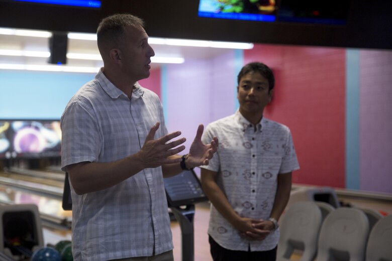 Col. Brian M. Howlett and Takayuki Kayo greet guests of the 22nd Annual Bowling Social during the annual Camp Hansen Festival at the bowling alley aboard Camp Hansen, Okinawa, Japan Sept. 3, 2016. (U.S. Marine Corps photo by Cpl. Janessa K. Pon)