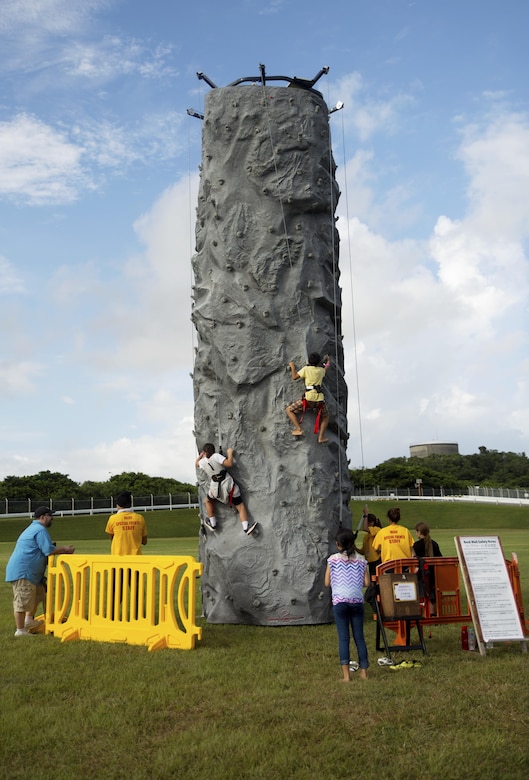 Children scale a rock-climbing wall during the 22nd Annual Camp Hansen Festival Sept. 3 aboard Camp Hansen, Okinawa, Japan. The annual festival is one of the quarterly open-gate events hosted by Camp Hansen that bridges the gap between Status of Forces Agreement personnel and Okinawa residents. More than 12,855 attendees came together during the two-day event to enjoy a vast array of ethnic foods, ride carnival rides, play games for prizes and rock out to a free concert by the headlining band, American Authors.