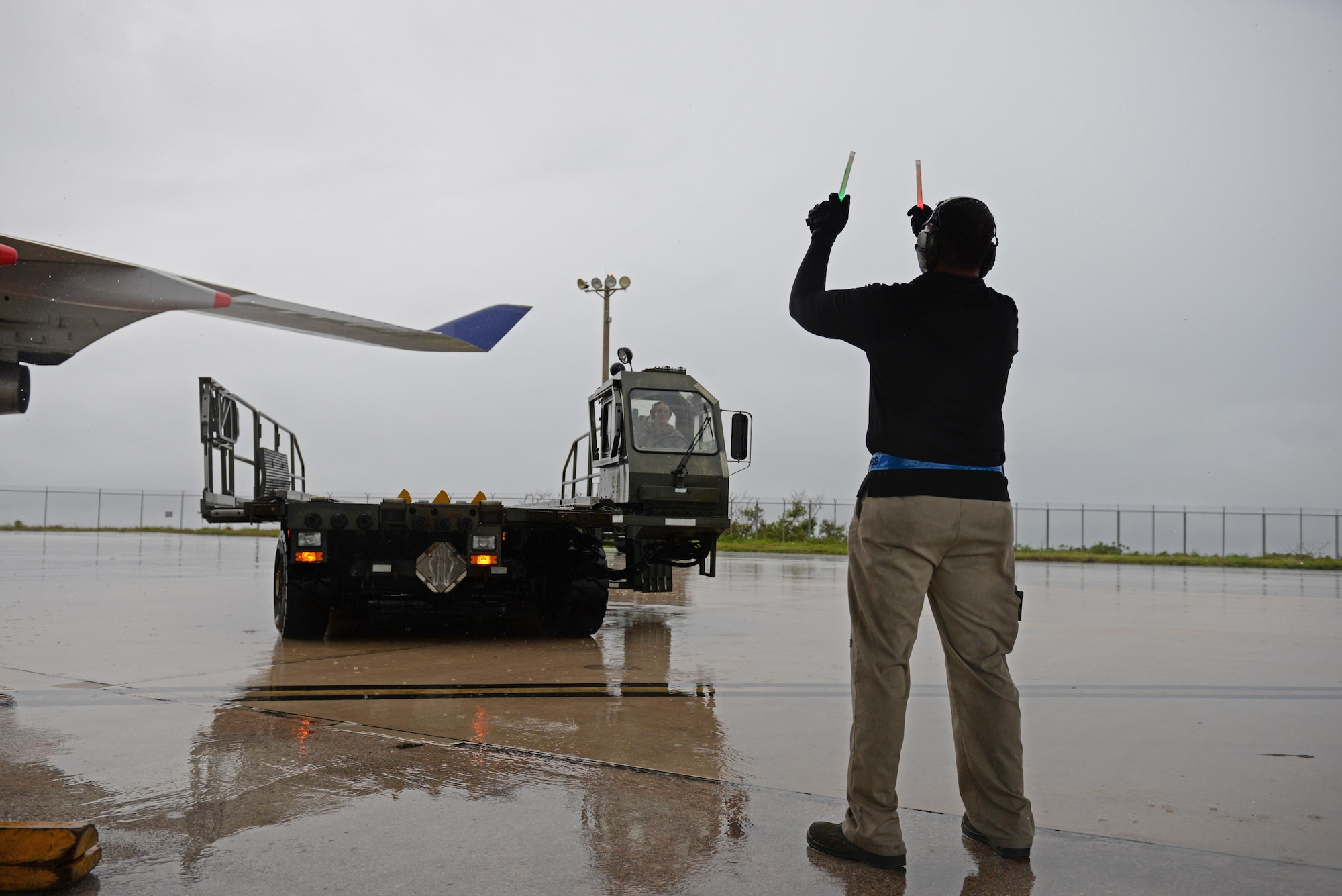 Fred San Nicolas, 734th Air Mobility Squadron load team chief, guides Senior Airman Hannah Stewart, 734th AMS aircraft services technician, as she drives a Halverson 25K aircraft cargo loader up to a Boeing 747 Sept. 7, 2016, at Andersen Air Force Base, Guam. The 734th AMS provides humanitarian relief and rapid response capabilities in the event of a natural disaster within the Indo-Asia-Pacific region. (U.S. Air Force photo by Airman 1st Class Jacob Skovo)