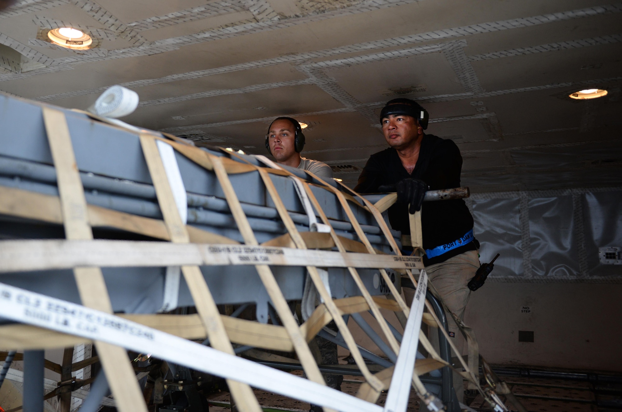Airman 1st Class Matthew Carpenter, left, 44th Air Maintenance Unit crew chief, and Fred San Nicolas, 734th Air Mobility Squadron load team chief, push an aircraft pallet Sept. 7, 2016, at Andersen Air Force Base, Guam. The 734th provides high velocity transportation of equipment, household goods, weapon systems and other essential cargo. (U.S. Air Force photo by Airman 1st Class Jacob Skovo)
