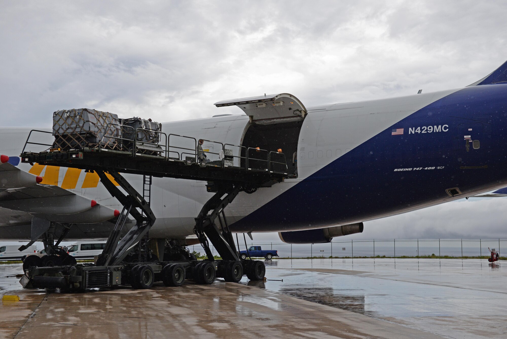 Airmen from the 734th Air Mobility Squadron unload a Boeing 747 onto a Tunner 60K aircraft cargo loader Sept. 7, 2016, at Andersen Air Force Base, Guam. The Tunner 60K aircraft cargo loader is capable of transporting up to six cargo pallets at a maximum speed of 23 mph. The vehicles deck elevates from 39 inches to 18 feet 6 inches high and employs a powered conveyor system to move cargo. (U.S. Air Force photo by Airman 1st Class Jacob Skovo)