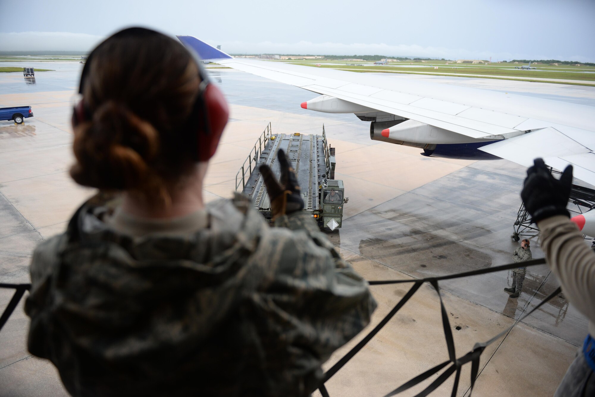 Senior Airman Hannah Stewart, 734th Air Mobility Squadron aircraft services technician, directs a Tunner 60K aircraft cargo loader as it approaches a Boeing 747 Sept. 7, 2016, at Andersen Air Force Base, Guam.The 734th AMS provides the capability to move cargo, personnel and equipment at a high velocity, ensuring Andersen AFB is prepared to meet mission requirements.(U.S. Air Force photo by Airman 1st Class Jacob Skovo)