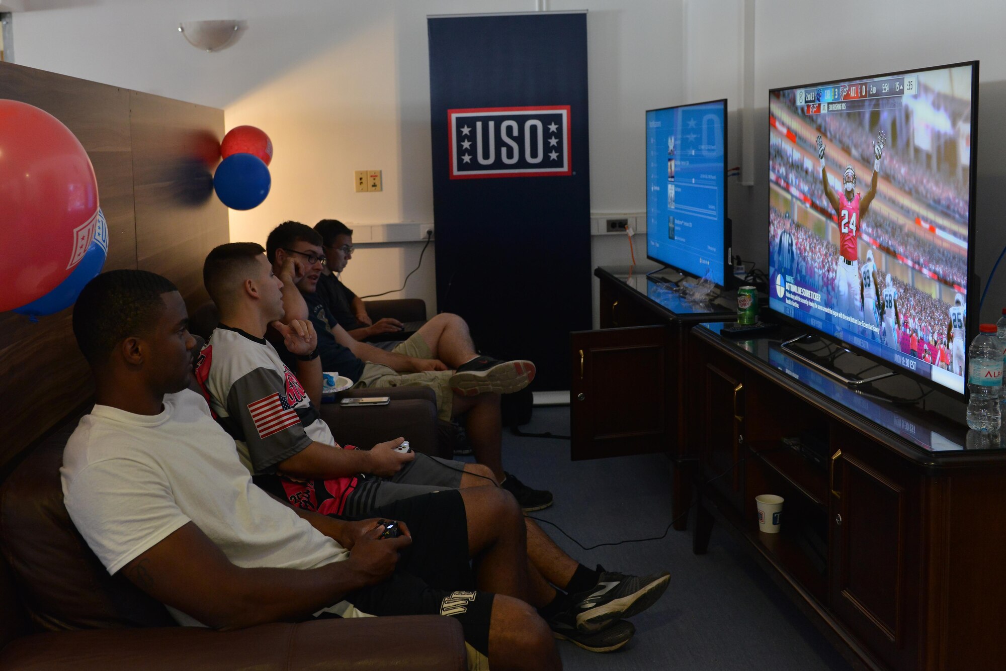 Servicemembers relax and play video games in USO Incirlik after its grand opening ceremony Sept. 23, 2016, at Incirlik Air Base, Turkey. Presently, USO Incirlik services nearly 350 individuals daily. (U.S. Air Force photo by Senior Airman John Nieves Camacho)