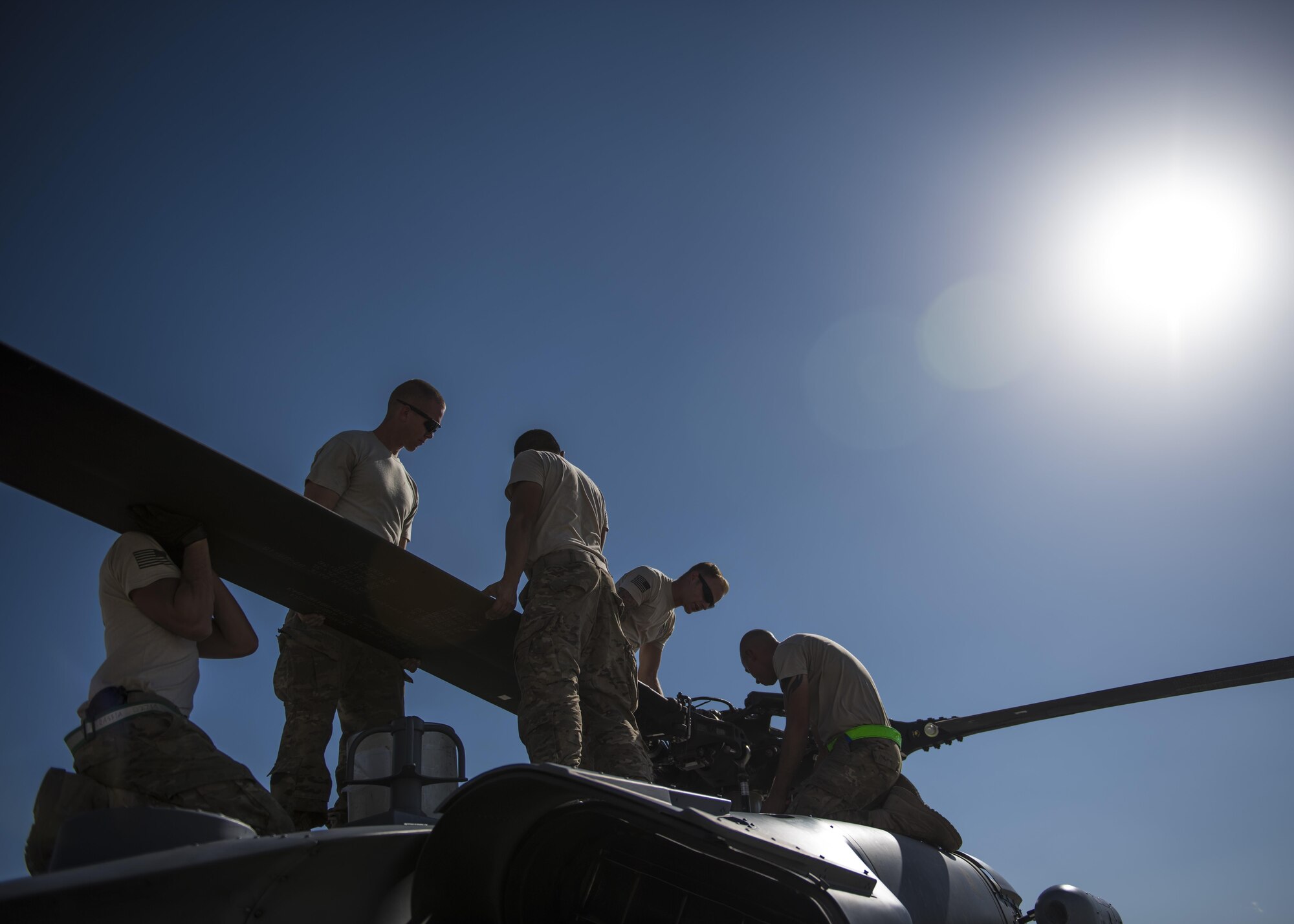 Airmen from the HH-60 Aircraft Maintenance Unit unfold the blades of a HH-60G Pave Hawk, Bagram Airfield, Afghanistan, Sept. 26, 2016. The 83rd Expeditionary Rescue Squadron provides the only U.S. personnel recovery assets in Afghanistan. HH-60G maintainers work a non-stop alert schedule and are ready to respond 24 hours a day, seven days a week. (U.S. Air Force photo by Senior Airman Justyn M. Freeman)
