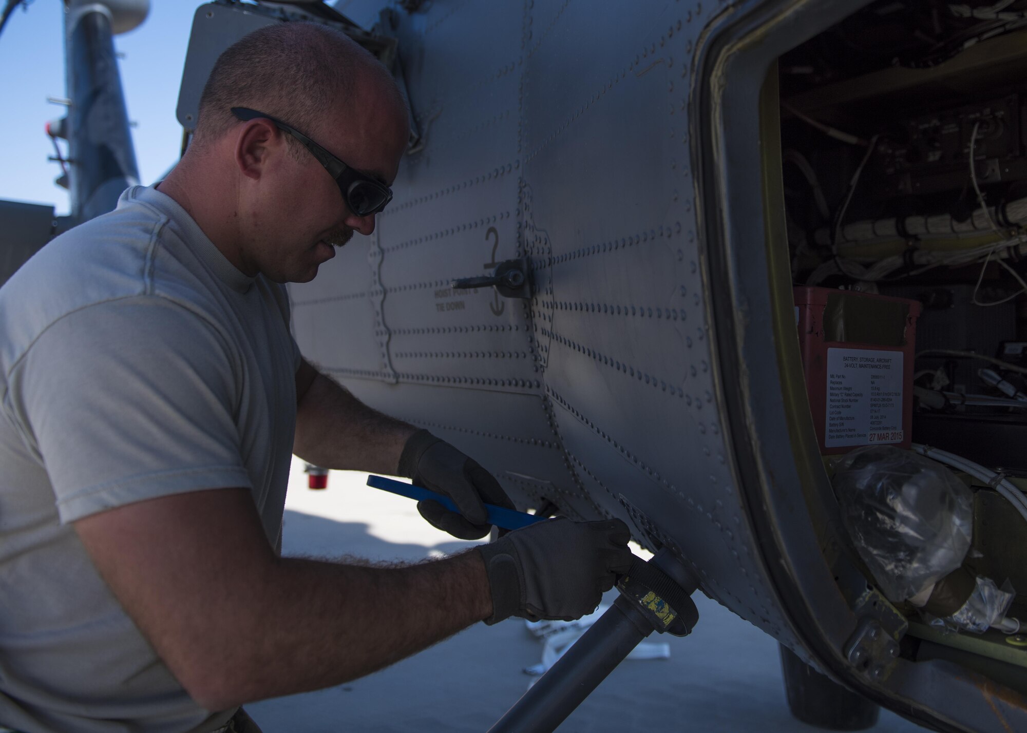 Staff Sgt. Michael Carrubba, HH-60 Aircraft Maintenance Unit, installs a fuel dump tube, Bagram Airfield, Afghanistan, Sept. 26, 2016. The fuel dump tube is taken off during transportation in an effort to keep it from breaking. (U.S. Air Force photo by Senior Airman Justyn M. Freeman)