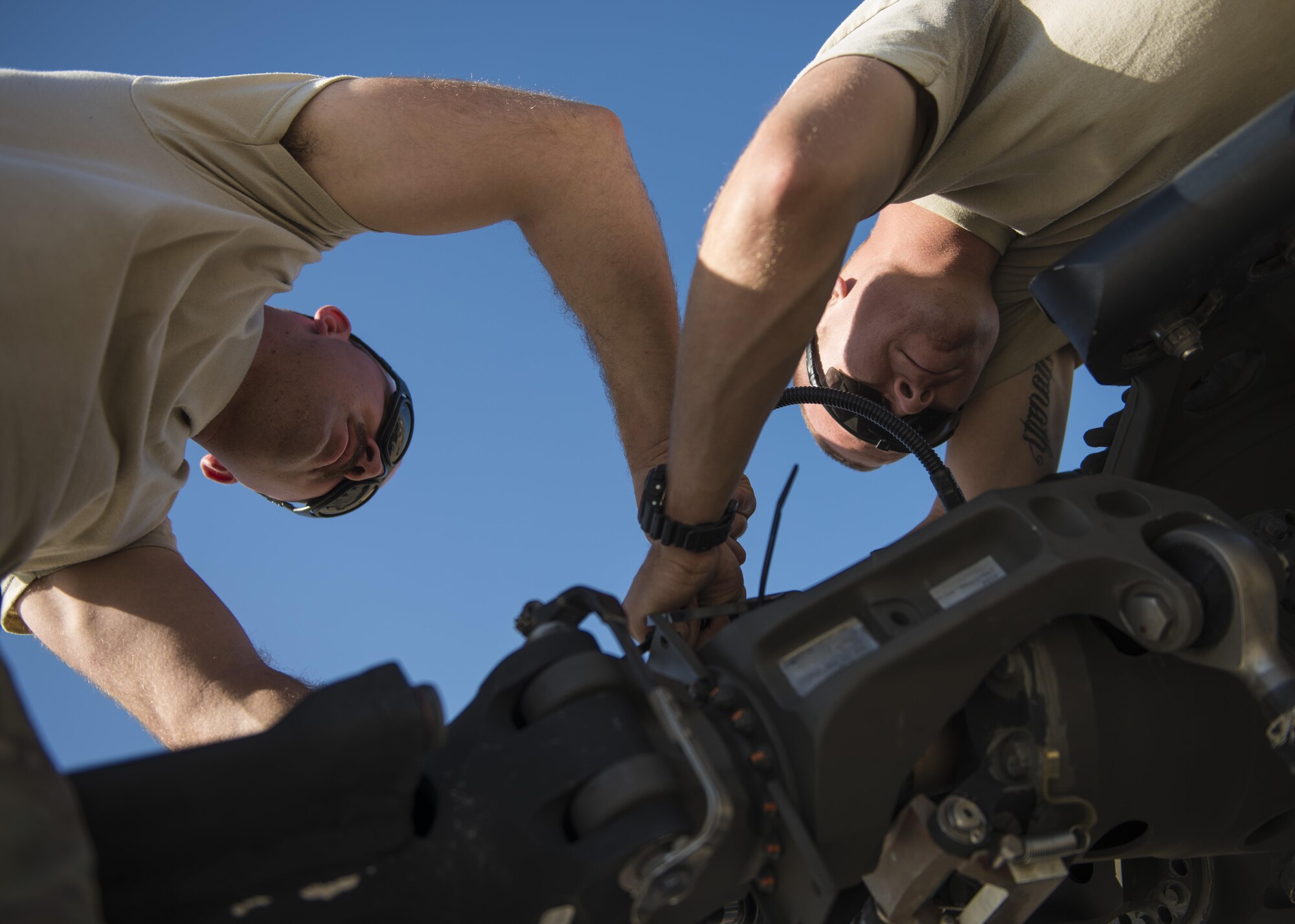 Staff Sgt. Michael Carrubba (left) and Senior Airman Douglas Wheeler (right), HH-60 Aircraft Maintenance Unit, lock rotor blades in place, Bagram Airfield, Afghanistan, Sept. 26, 2016. The 83rd ERQS provides the only U.S. personnel recovery assets in Afghanistan. HH-60G maintainers work a non-stop alert schedule and are ready to respond 24 hours a day, seven days a week. (U.S. Air Force photo by Senior Airman Justyn M. Freeman)