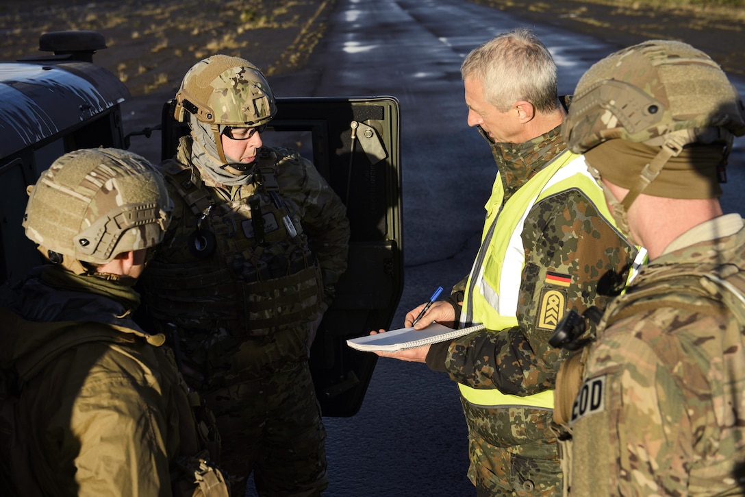Airmen discuss their mission during Northern Challenge 16 at Icelandic Coast Guard Keflavik Facility, Iceland, Sept. 19, 2016. The airmen are assigned to the 52nd Civil Engineer Squadron. Northern Challenge 16 is an explosive ordnance disposal and counter-improvised explosive device exercise supporting NATO’s Defense Against Terrorism program. Air Force photo by Staff Sgt. Jonathan Snyder