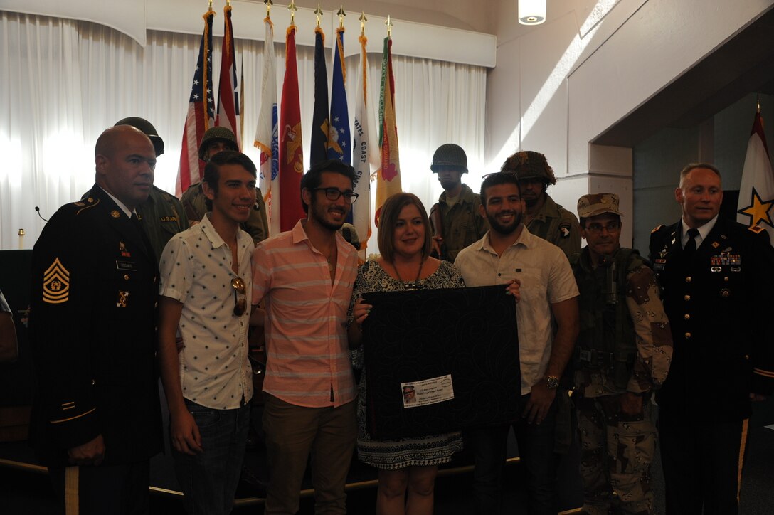 The Family of a fallen Soldier, Sgt. Miguel Ramos Vargas, Army, received a quilt alongside Fort Buchanan Garrison leadership, Col. Michael T. Harvey, Command Sgt. Maj. Luis A. Rosario, and re-en actors from previous eras at the Chapel in Fort Buchanan, Puerto Rico.