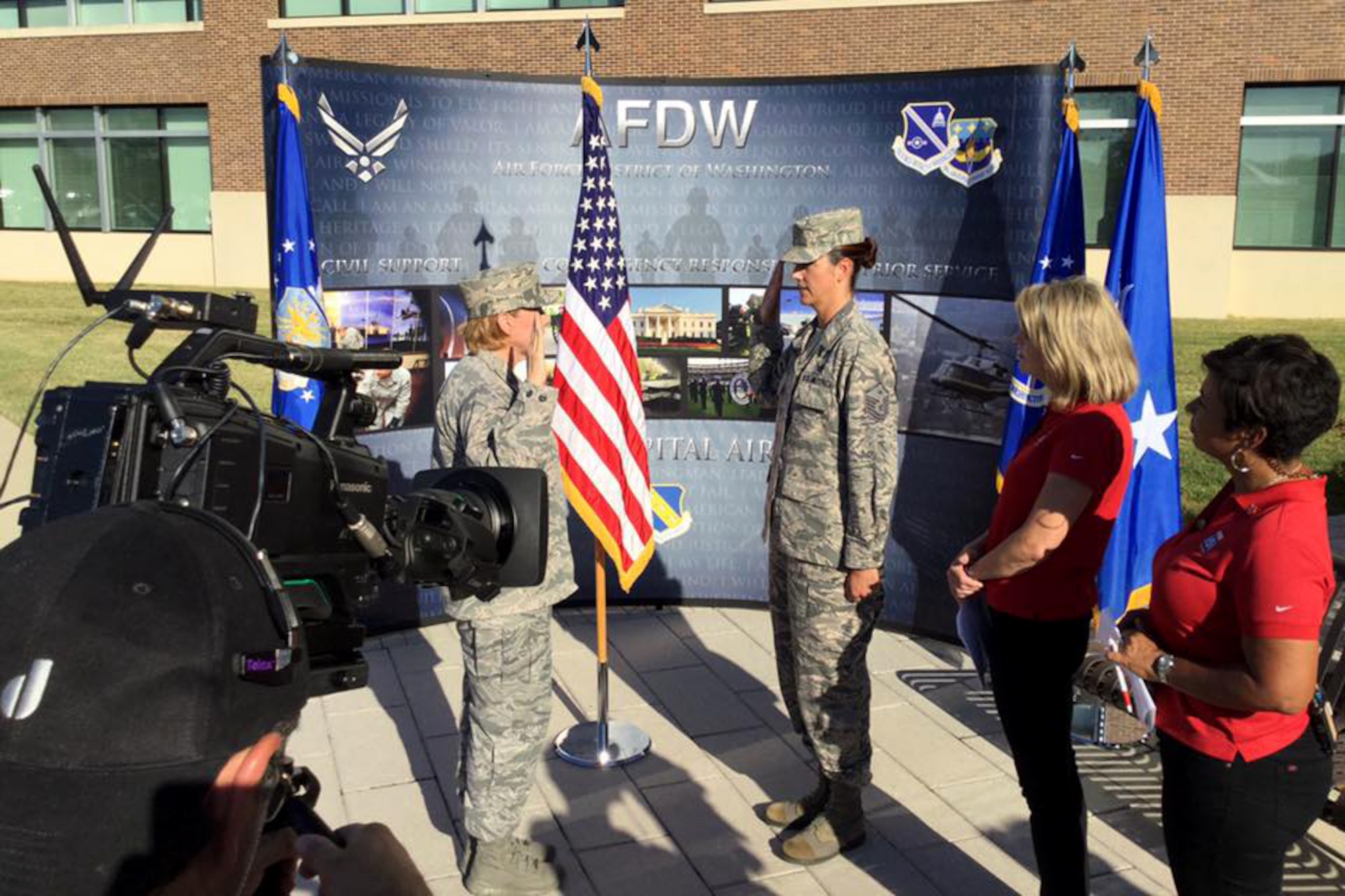 Col. Sharon Bannister, AFMS 79th Medical Wing commander, reenlists MSgt. Valerie Moore, 779th Medical Group first sergeant, during a live broadcast with Fox 5 DC at Joint Base Andrews on Sep. 23, 2016. AFDW hosted Fox5 DC for a live broadcast of FOX 5 News Morning and Good Day DC live from JBA in celebration of the Air Force’s 69th Birthday. (U.S. Air Force photo/Tech. Sgt. Matt Davis)