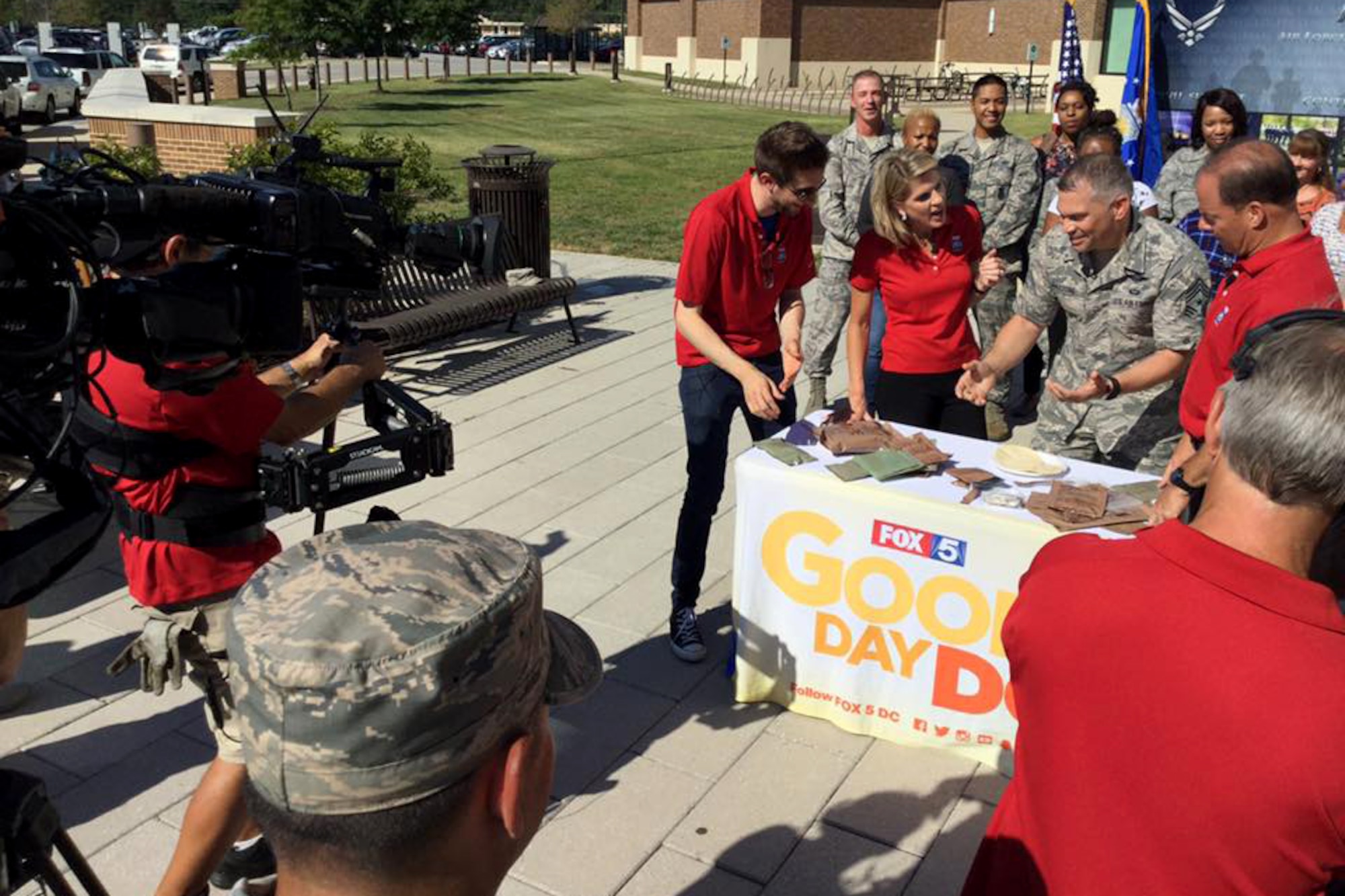 Air Force District of Washington Command Chief Master Sgt. Tommy Mazzone shows the Fox 5 DC team how to prepare meals ready to eat (MREs) during a live broadcast at Joint Base Andrews on Sep. 23, 2016. AFDW hosted Fox5 DC for a live broadcast of FOX 5 News Morning and Good Day DC live from JBA in celebration of the Air Force’s 69th Birthday. (U.S. Air Force photo/Tech. Sgt. Matt Davis)