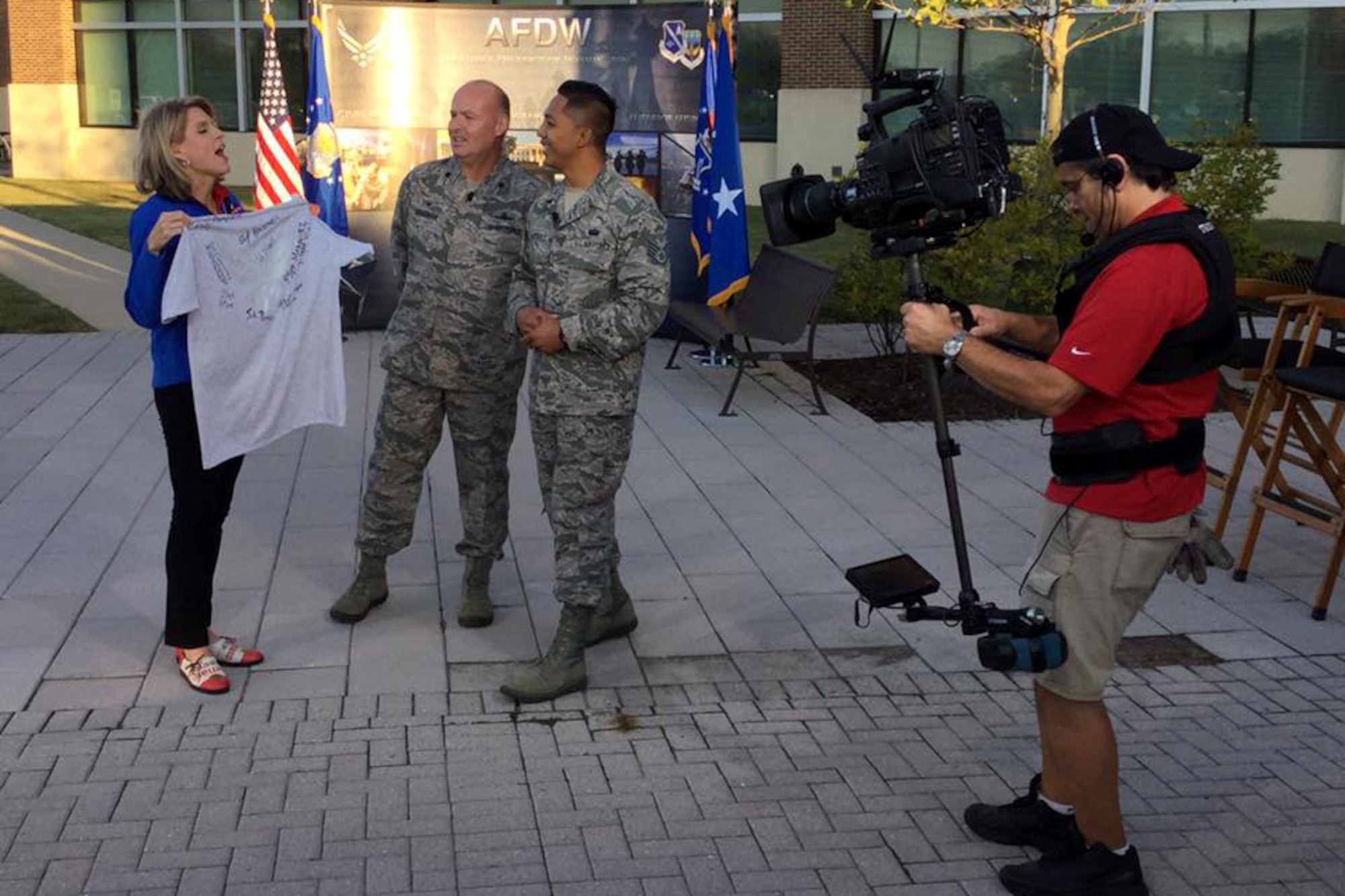 Fox 5 DC Anchor Holly Morris speaks with Lt. Col. Jon Goodman, 744th Communications Squadron commander, and Staff Sgt. Mario Marquez, 744th CS physical training leader, at Joint Base Andrews on Sep. 23, 2016. AFDW hosted Fox5 DC for a live broadcast of FOX 5 News Morning and Good Day DC live from JBA in celebration of the Air Force’s 69th Birthday. (U.S. Air Force photo/Tech. Sgt. Matt Davis)