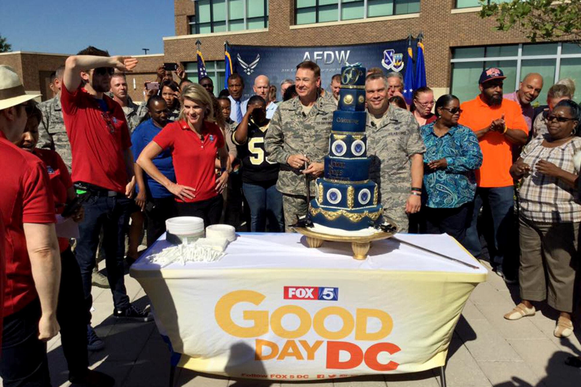 Air Force District of Washington Commander Maj. Gen. Darryl Burke and AFDW Command Chief Master Sgt. Tommy Mazzone celebrate the United States Air Force's 69th birthday with the Fox 5 DC team at Joint Base Andrews on Sep. 23, 2016. AFDW hosted Fox5 DC for a live broadcast of FOX 5 News Morning and Good Day DC live from JBA in celebration of the Air Force’s 69th Birthday. (U.S. Air Force photo/Tech. Sgt. Matt Davis)