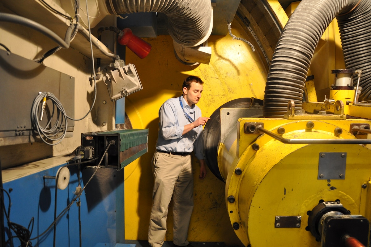 Test Manager Andrew Zakrajsek, 96 TG/OL-AC, inspects tire in advanced development of missionized aircraft tire wear testing for F-35 program. (U.S. Air Force Photo)
