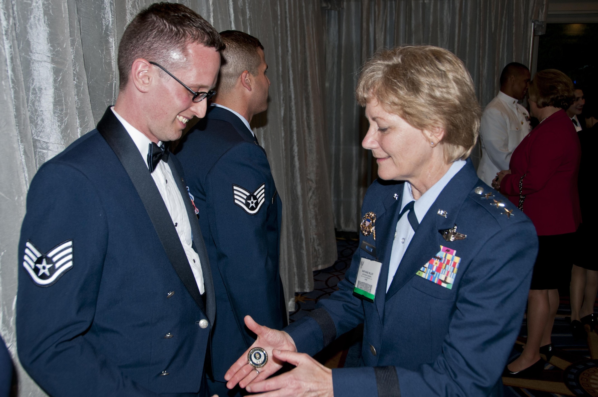 Lt. Gen. Maryanne Miller, chief of the Air Force Reserve and commander, Air Force Reserve Command, presents Staff Sgt. Aaron Tobler with a Chief of the Air Force Reserve coin during the Air Force Association banquet recognizing the Air Force's 12 Outstanding Airmen of the Year in Washington, D.C., Sept. 19, 2016. Tobler is a geospatial intelligence analyst with the 50th Intelligence Squadron, Beale Air Force Base, California.
