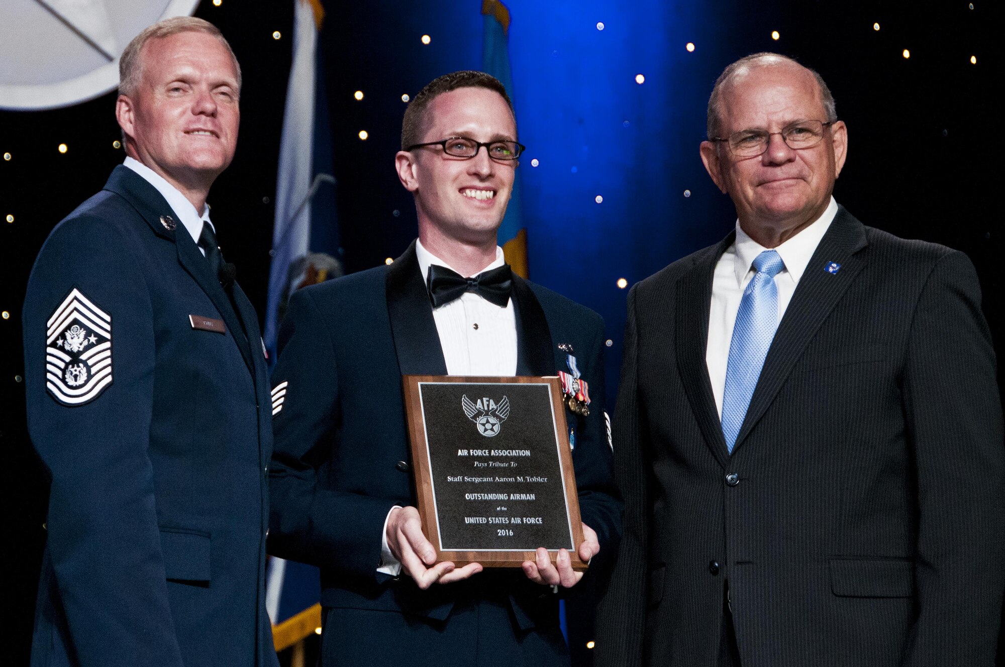 Staff Sgt. Aaron Tobler, center, with Chief Master Sgt of the Air Force James Cody and Scott Van Cleef, Air Force Association Chairman of the Board, during the AFA's recognition banquet in Washington, D.C., honoring the Air Force's 12 Outstanding Airmen of the Year, Sept. 19, 2016.  Tobler is a geospatial intelligence analyst with the 50th Intelligence Squadron, Beale Air Force Base, California. The 50th IS is a classic associate intelligence unit under the 655th Intelligence, Surveillance and Reconnaissance Group, Wright-Patterson AFB, Ohio. 