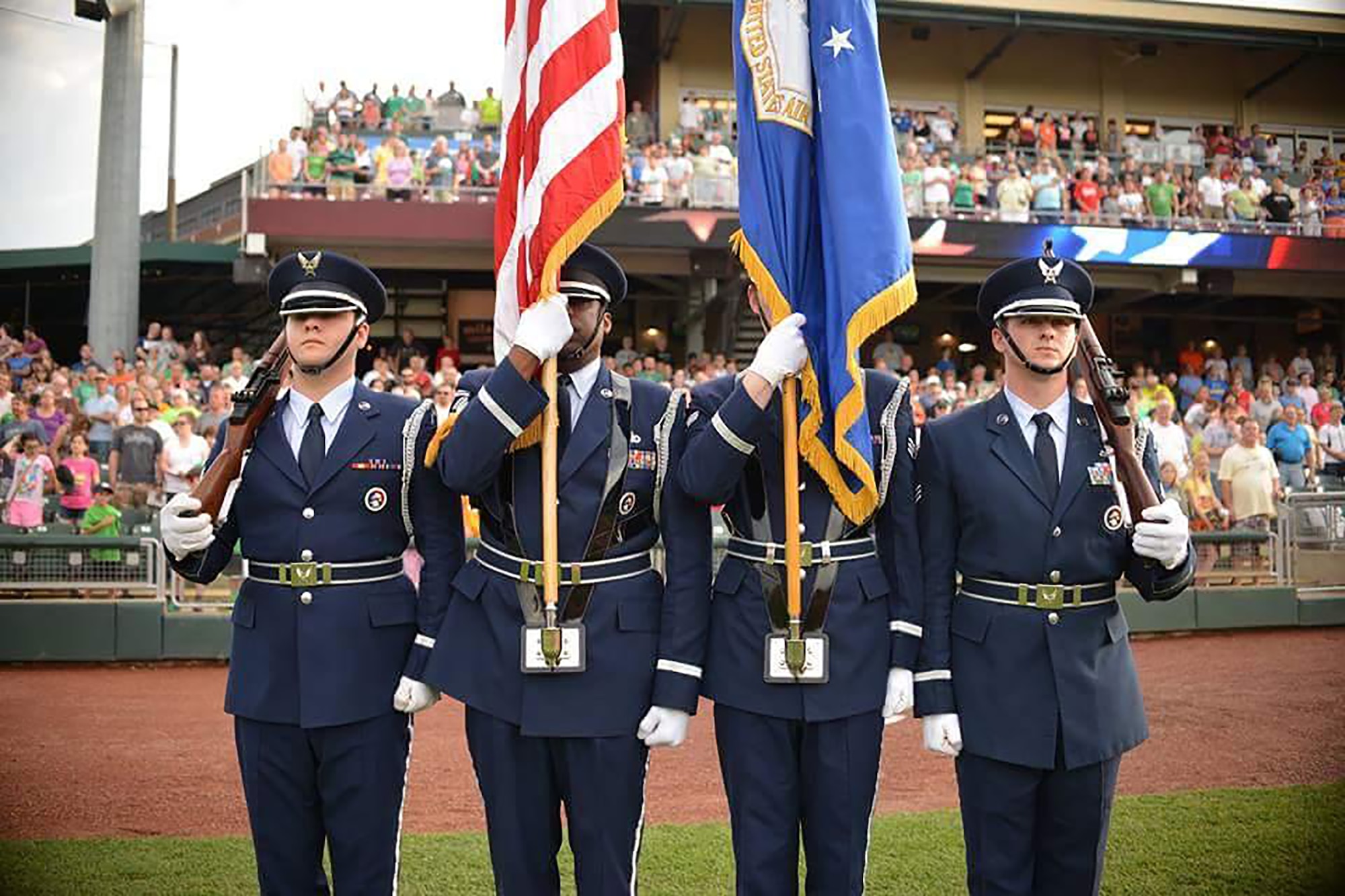 Members of the Wright-Patterson Air Force Base Honor Guard perform at a Dayton Dragons baseball game earlier this year. Senior Airman Joseph Divish, far right, is a Citizen Airman in the 87th Aerial Port Squadron. (Courtesy photo)