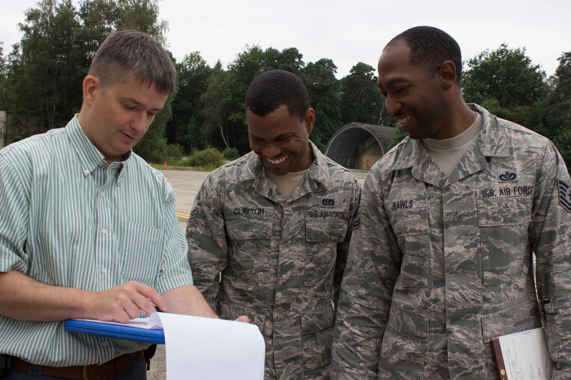 From left, Blaine Benson, Staff Sgt. Terry Clayton and Tech. Sgt. Quentin Rawls discuss facility drawings prior to evaluating a building at Ramstein Air Base, Germany. Benson is a member of the AFCEC asset visibility team who recently travelled to Ramstein to train, validate and calibrate the facility condition assessments at the base. (U.S. Air Force Photo/Susan Lawson)

