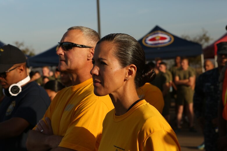 U.S. Navy Capt. Peter Ruocco and Master Chief Petty Officer Anna Wood listen to the guest speaker at the 2nd annual Suicide Prevention Awareness Walk aboard Camp Pendleton, Calif., Sept. 23, 2016. Ruocco is the commanding officer of 1st Dental Battalion, 1st Marine Logistics Group, and Wood is the unit’s command master chief. The walk was held to increase awareness about suicide and highlight the resources available to help those in need. (U.S. Marine Corps photo by Lance Cpl. Joseph Sorci)