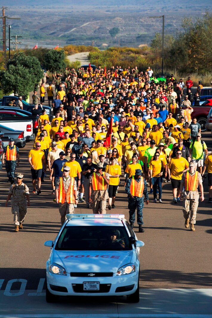 Marines and Sailors follow the pace car at the start of the 2nd annual Suicide Awareness and Prevention Walk aboard Camp Pendleton, Calif., Sept. 23, 2016. The walk was held to increase awareness about suicide and highlight the resources available to help those in need. (U.S. Marine Corps photo by Sgt. Abbey Perria)