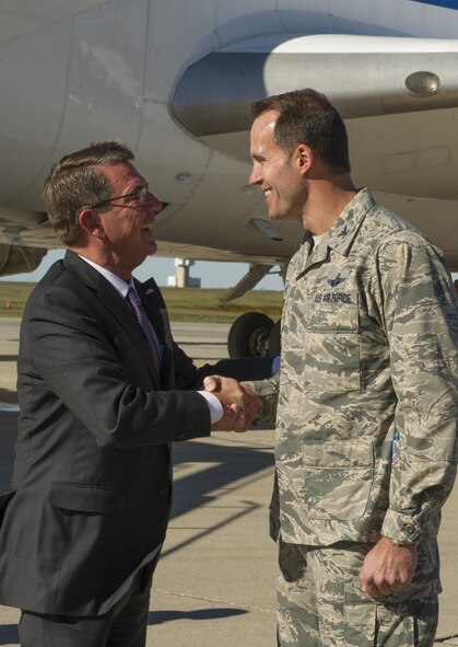 U.S. Secretary of Defense Ashton Carter, greets Col. Matthew Brooks, 5th Bomb Wing commander, during a visit to Minot Air Force Base, N.D., Sept. 26, 2016. Carter spoke with Airmen from the 5th BW and 91st Missile Wing and toured several facilities, to include a missile alert facility and a B-52H Stratofortress static display. To conclude his visit, Carter hosted a question and answer session with base personnel and recognized top performing Airmen. (U.S. Air Force photo/Senior Airman Apryl Hall)