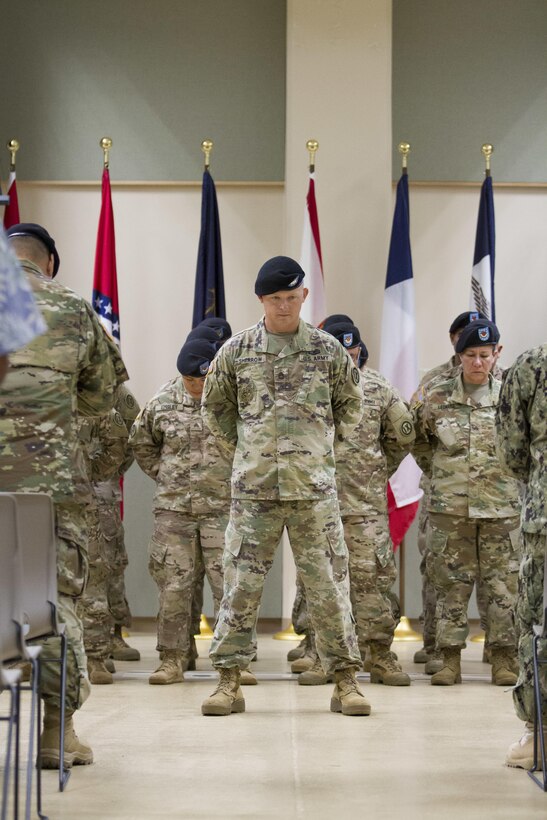 BARRIGADA, Guam – U.S. Army Sergeant 1st Class William Sherrow (center), the noncommissioned officer in-charge for Detachment 5, 368th Military Police Company, and his fellow Soldiers standing behind bow their heads for the invocation during a deployment ceremony at the Guam Army National Guard Assembly Hall on Saturday, Sept. 24. The detachment is the first Guam-based Army reserve unit to successfully conduct home station mobilization operations and to deploy out of Guam.