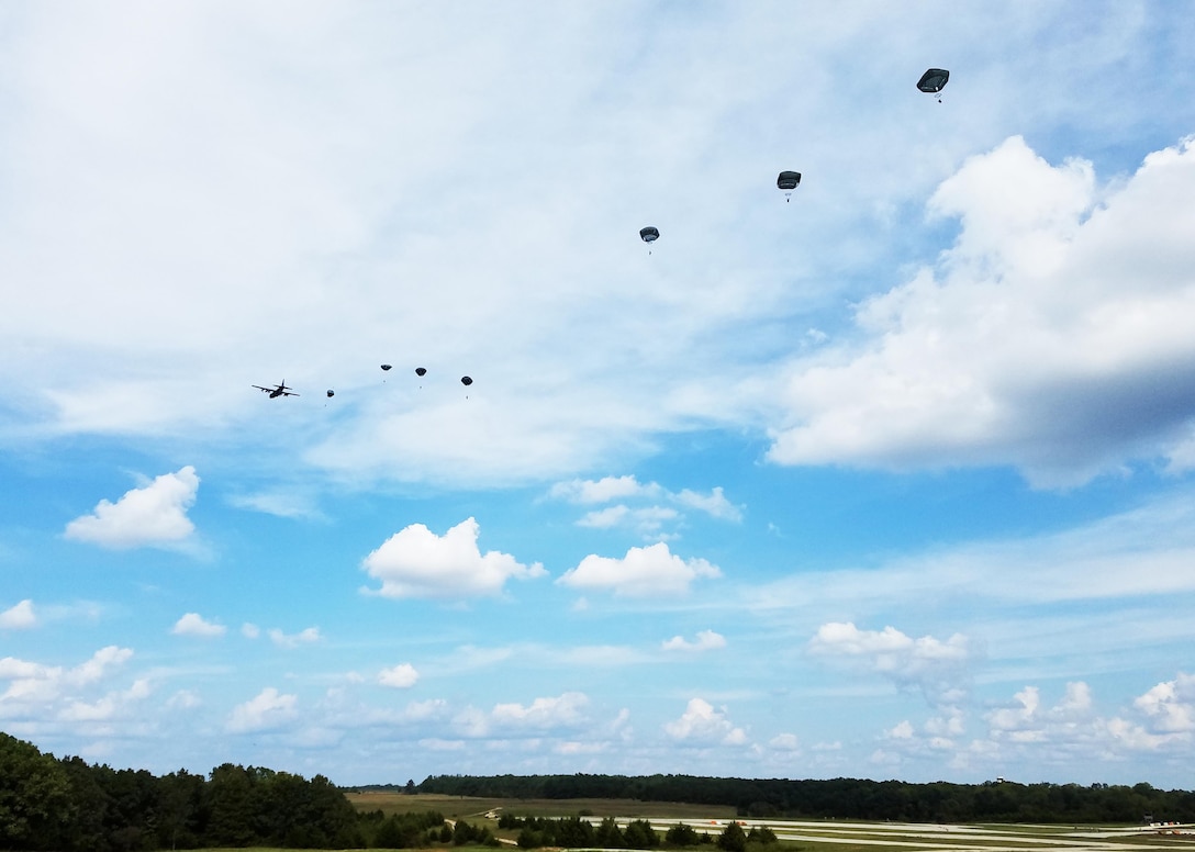 Military police paratroopers jump from a C-130 Sept. 20 at Fort Leonard Wood, Missouri. MPs attended events throughout the week to mark the regiment's 75th anniversary. (U.S. Army photo by Sgt. 1st Class Jacob Boyer/Released)