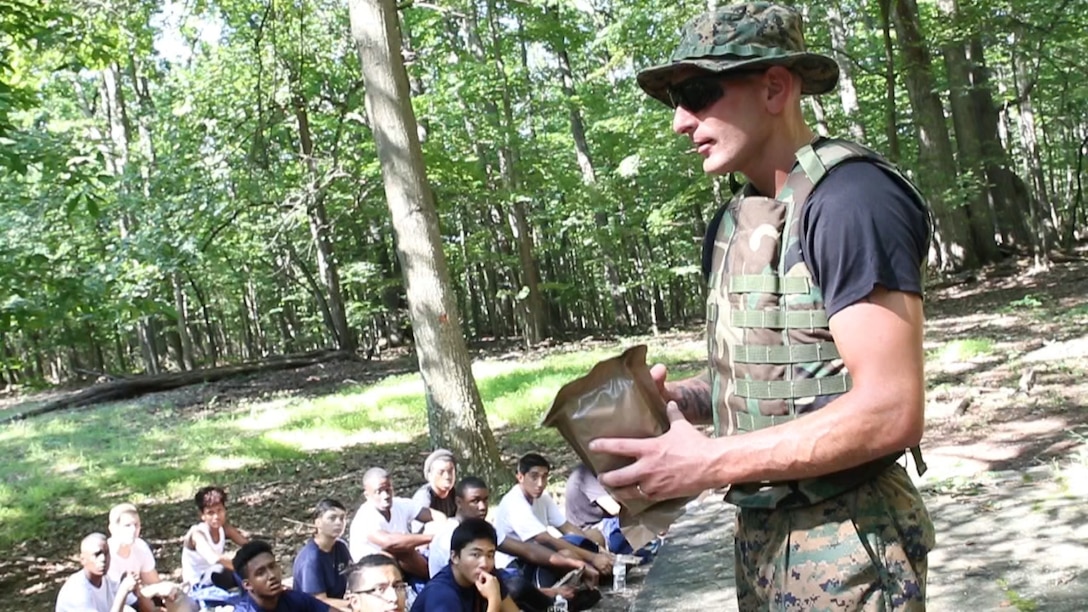 U.S. Marine Staff Sgt. Nicholas Safran teaches future Marines about the contents of a Meal-Ready-To-Eat at Sugarloaf Mountain in Urbana, Maryland, Aug. 20. Each future Marine had a bag that contained one MRE, two bottles of water, and one sports drink to get them through a 3.31-mile hike. Safran is the staff noncommissioned officer in charge of Recruiting Sub-station Rockville, Recruiting Station Frederick. (Official U.S. Marine Corps Photo by Sgt. Anthony J. Kirby/Released)