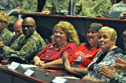 Beverly Balsley (center) smiles while listening to a speech at a Gold Star Family Day event hosted by the 63rd Regional Support Command, Sept. 24, Armed Forces Reserve Center, Mountain View, Calif. An improvised explosive device killed her son Spc. Michael Balsley on Jan. 25, 2007, while on patrol near Baghdad, as he served with the 2nd Infantry Division as a cavalry scout. (U.S. Army Reserve Photo by Capt. Alun Thomas)