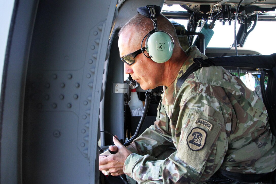 Army Maj. Gen. Timothy Orr, adjutant general of Iowa, flies in a UH-60 Black Hawk helicopter to survey the devastation from flooding in Green and Charles City, Iowa, Sept. 26, 2016. State and local Iowa officials met with emergency response teams to discuss damage and the needs of Iowa residents. Iowa Air National Guard photo by Tech. Sgt. Linda K. Burger 