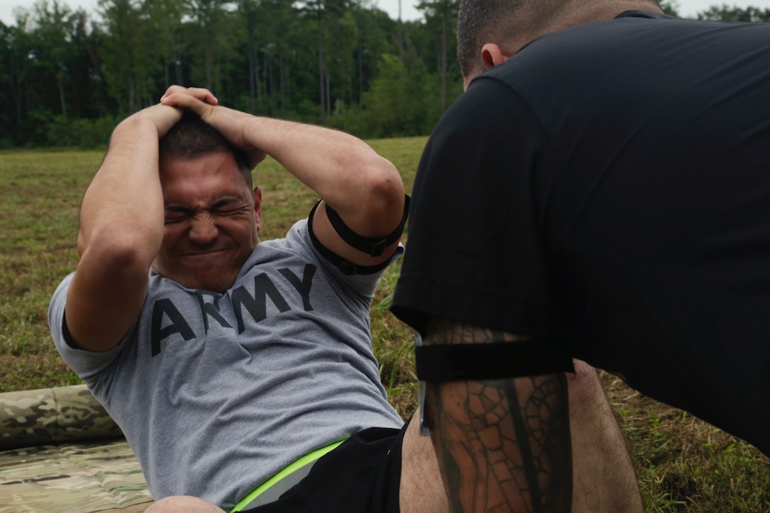 U.S. Army Spc. Michael Orozco, assigned to U.S. Army Reserve Command, participates in the sit-up event as part of the Army Physical Fitness Test at Fort A.P. Hill, Va., Sept. 26, 2016. The APFT was part of the U.S. Army 2016 Best Warrior Competition, a weeklong event that tests the skills, professionalism and knowledge of 20 warriors representing 10 commands. (U.S. Army photo by Pfc. Fransico Isreal)