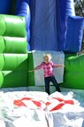 Anna Hagberg flies into an inflatable slide landing zone of during Nickelodeon’s Worldwide Day of Play event held in Patriot Park, at Peterson Air Force Base, Colorado, Saturday, Sept. 24, 2016. This event featured a 2K color run, inflatable obstacle courses, games and featured various vendor booths and raffles. (U.S. Air Force photo/Brian Hagberg)