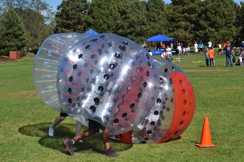 Children play a game of knockerball during the Worldwide Day of Play at Peterson Air Force Base, Colorado, Saturday, Sept. 24, 2016. The annual event encourages children and their families to go outside and play. (U.S. Air Force photo/Brian Hagberg)