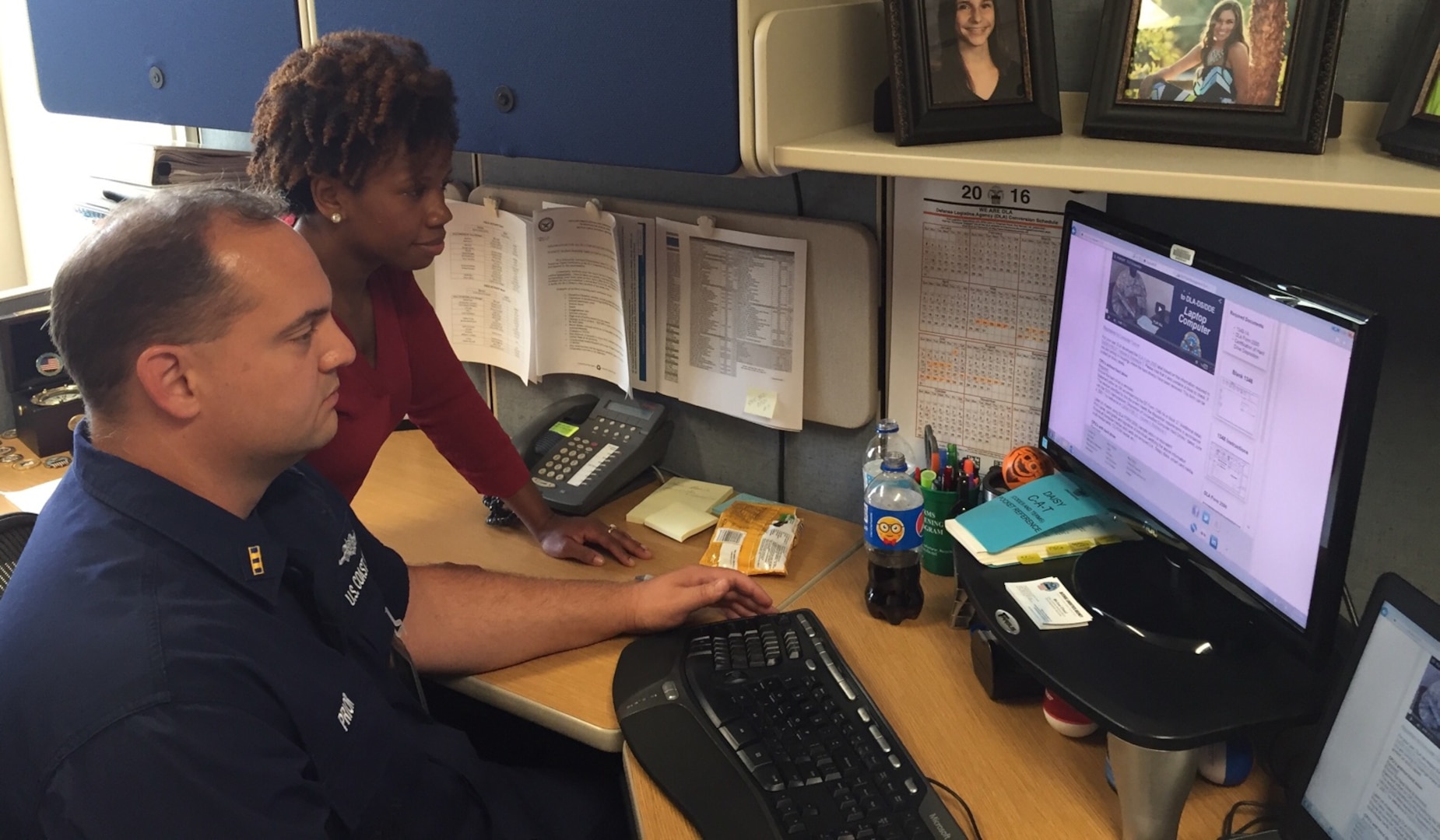 Defense Logistics Agency employee Angela Patterson (left) and Coast Guard Chief Warrant Officer Marcus Pryor (right) view the new Digital DSR tool. 
