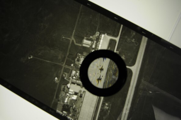 A section of Optical Bar Camera duplicate film is magnified using a loupe, showing two U-2 aircraft on the flightline at Beale Air Force Base, Calif. The OBC is carried by the U-2, which routinely flies at an altitude of more than 70,000 feet. (U.S. Air Force photo/Airman 1st Class Taylor A. Workman)