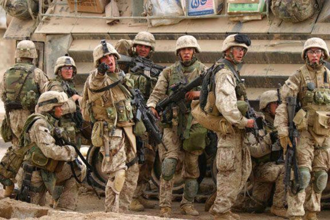 Second from right: Marine Corps Sgt. Alexander Munoz, 3rd Battalion, 1st Marines, lines up with the 5th Marines, as the platoon sergeant orders the Marines to clear a building in the second push during Operation Phantom Fury in Fallujah, Iraq, in 2004. Courtesy photo