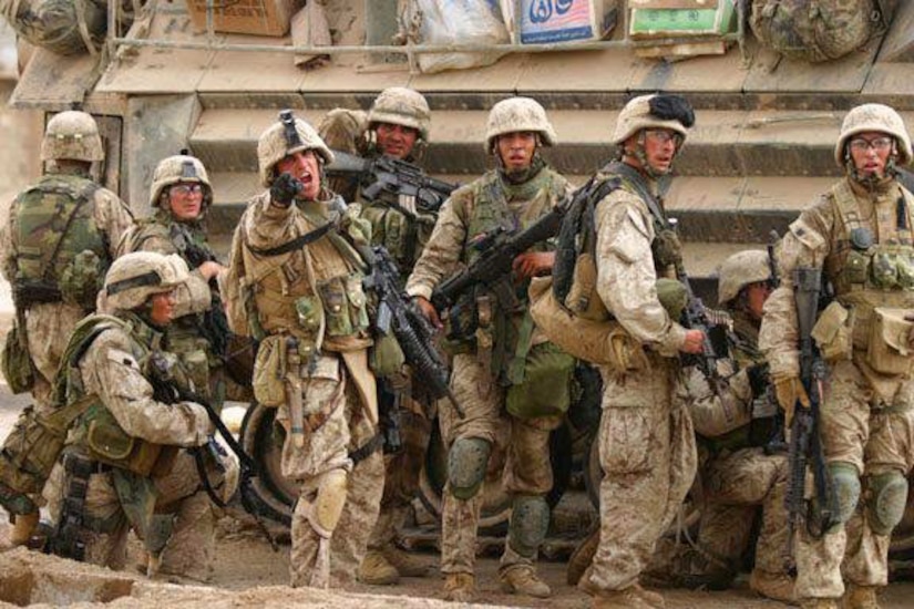 Second from right: Marine Corps Sgt. Alexander Munoz, 3rd Battalion, 1st Marines, lines up with the 5th Marines, as the platoon sergeant orders the Marines to clear a building in the second push during Operation Phantom Fury in Fallujah, Iraq, in 2004. Courtesy photo