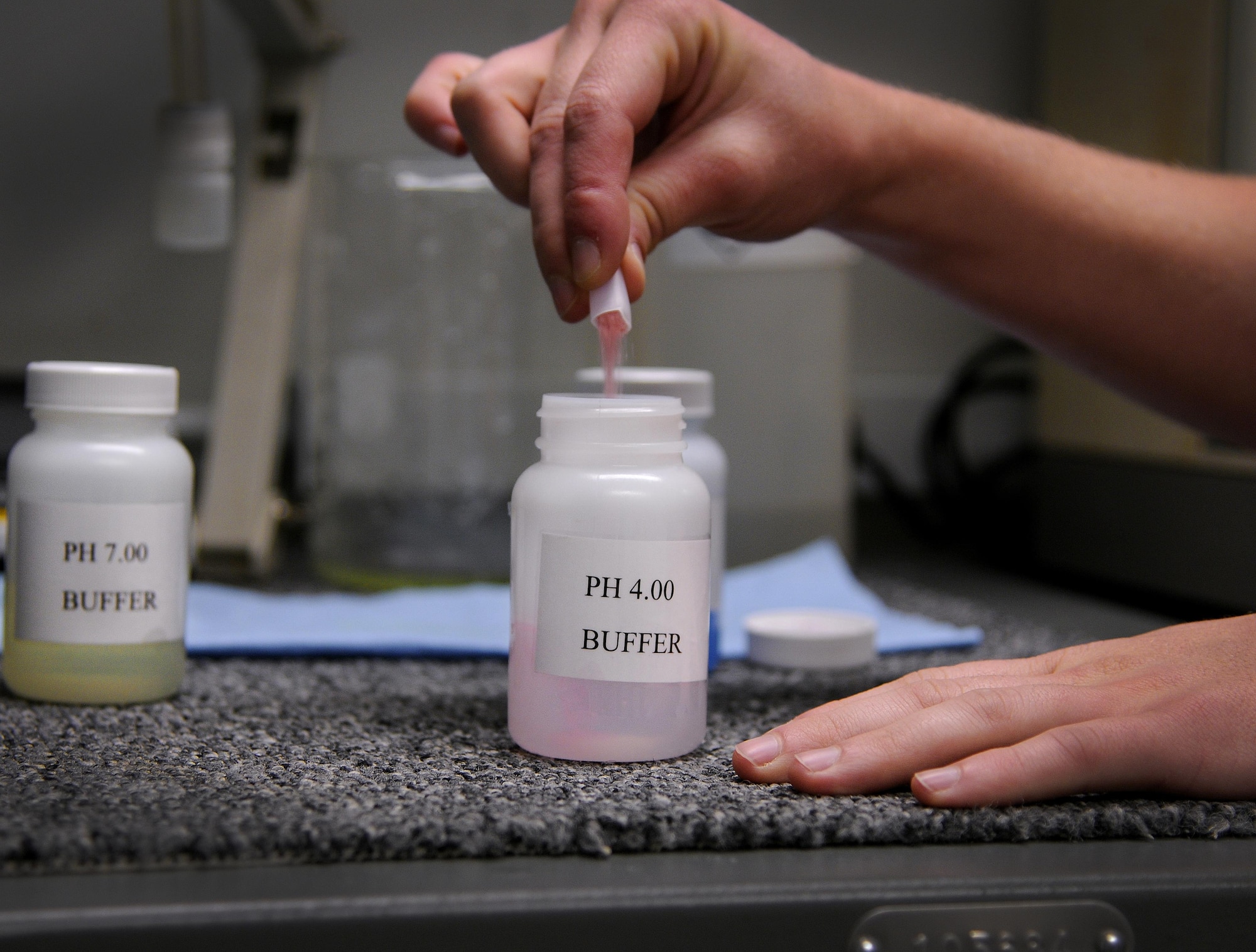 Senior Airman Shana Wojcik, 9IS quality assurance section lead, mixes a solution that aids in chemical testing Sept. 14, 2016, at Beale Air Force Base, California. The QA section is responsible for ensuring the film is developed properly by the chemicals within the Versamat 1140 film processor. (Air Force photo by Airman 1st Class Taylor A. Workman)