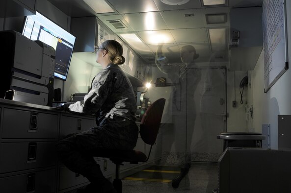 Senior Airman Dana Cable and Senior Airman Shana Wojcik, both are 9th Intelligence Squadron quality assurance specialists, analyze and record film density tests Sept. 14, 2016, at Beale Air Force Base, Calif. Quality assurance manages all Optical Bar Camera film products by ensuring machines are functioning without error and the chemistry is developing the film properly. (U.S. Air Force photo/Airman 1st Class Taylor A. Workman)