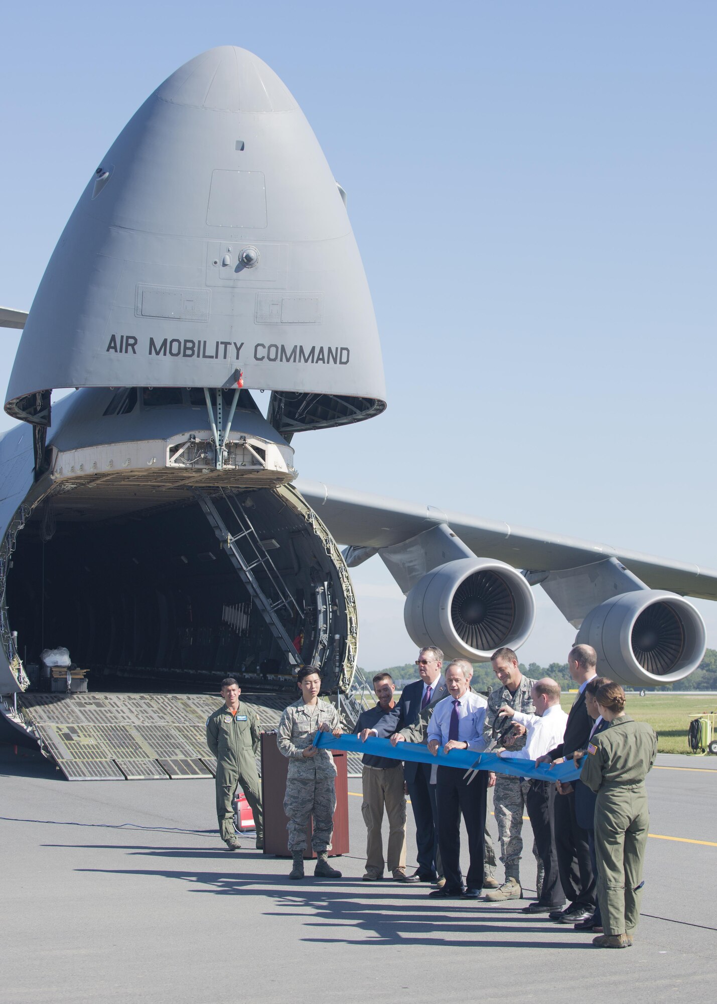 Col. Ethan Griffin, 436th Airlift Wing commander, and Sen. Chris Coons, D-Del.,; cut a ribbon marking the reopening of Runway 01-19 during anafter completion of Phase II of an extensive reconstruction project Sept. 23, 2016, at Dover Air Force Base, Del. Shown from left, Airman 1st Class Joseph Cho, 436th Aircraft Maintenance Squadron; Tony Price, sub-contractor representative; Jeff Wagonhurst, Versar Inc. president and CEO; Col. Scott Durham, 512th AW commander; Sen. Tom Carper, D-Del.; Col. Ethan Griffin, 436th AW commander; Sen. Chris Coons, D-Del.; Drew Slater, Rep. John Carney D-Del. representative; Robin Christiansen, Mayor of Dover; and Airman 1st Class Paula Padilla, 9th Airlift Squadron loadmaster. (U.S. Air Force photo by Staff Sgt. Jared Duhon)  