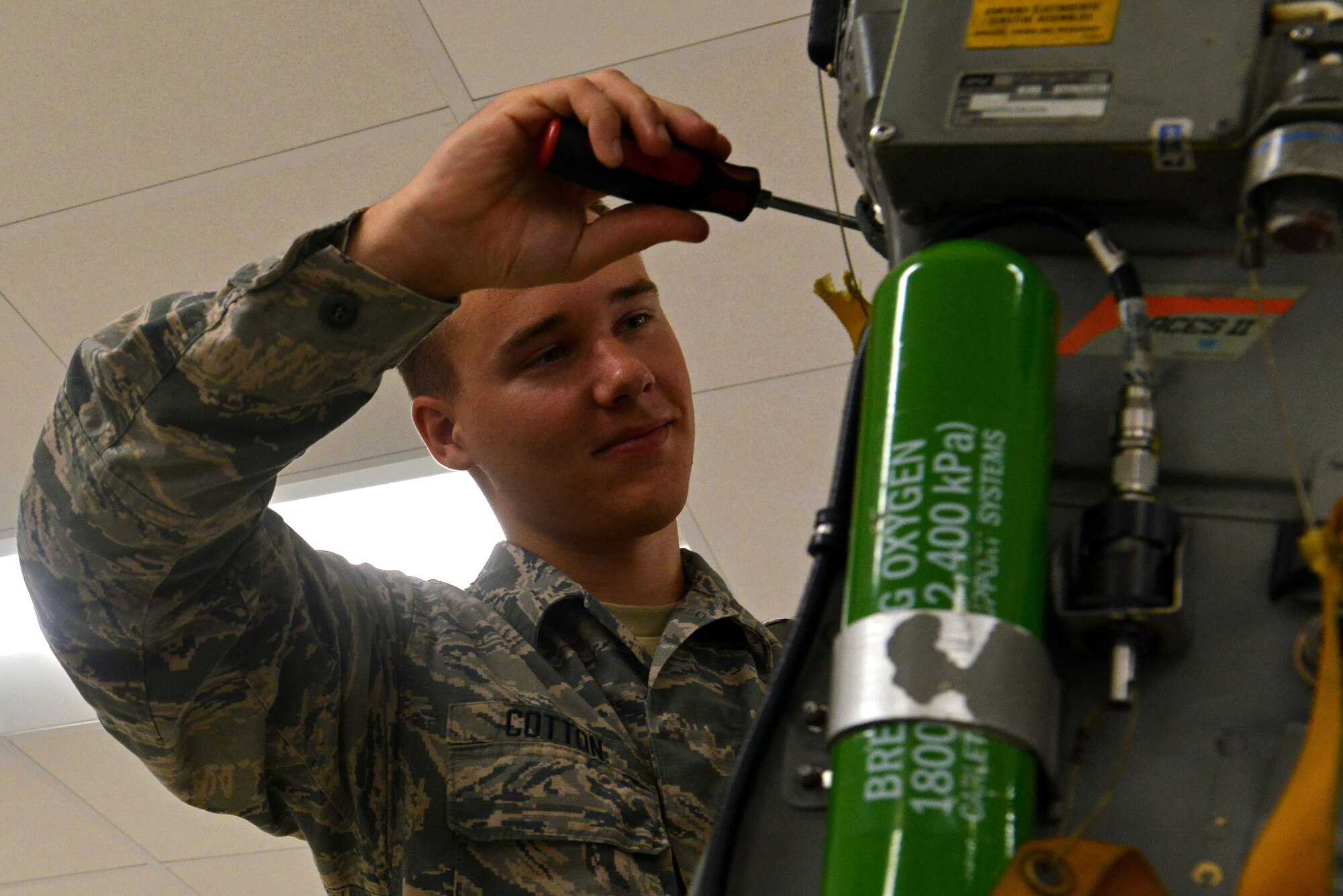 U.S. Air Force Airman Nicholas Cotton, 20th Component Maintenance Squadron egress apprentice, installs a newly-repaired headrest onto an F-16CM Fighting Falcon seat at Shaw Air Force Base, S.C., Sept. 22, 2016. The 20th CMS egress flight is responsible for inspecting and maintaining F-16 seats, canopies and ejection explosives. (U.S. Air Force photo by Airman 1st Class Destinee Sweeney)