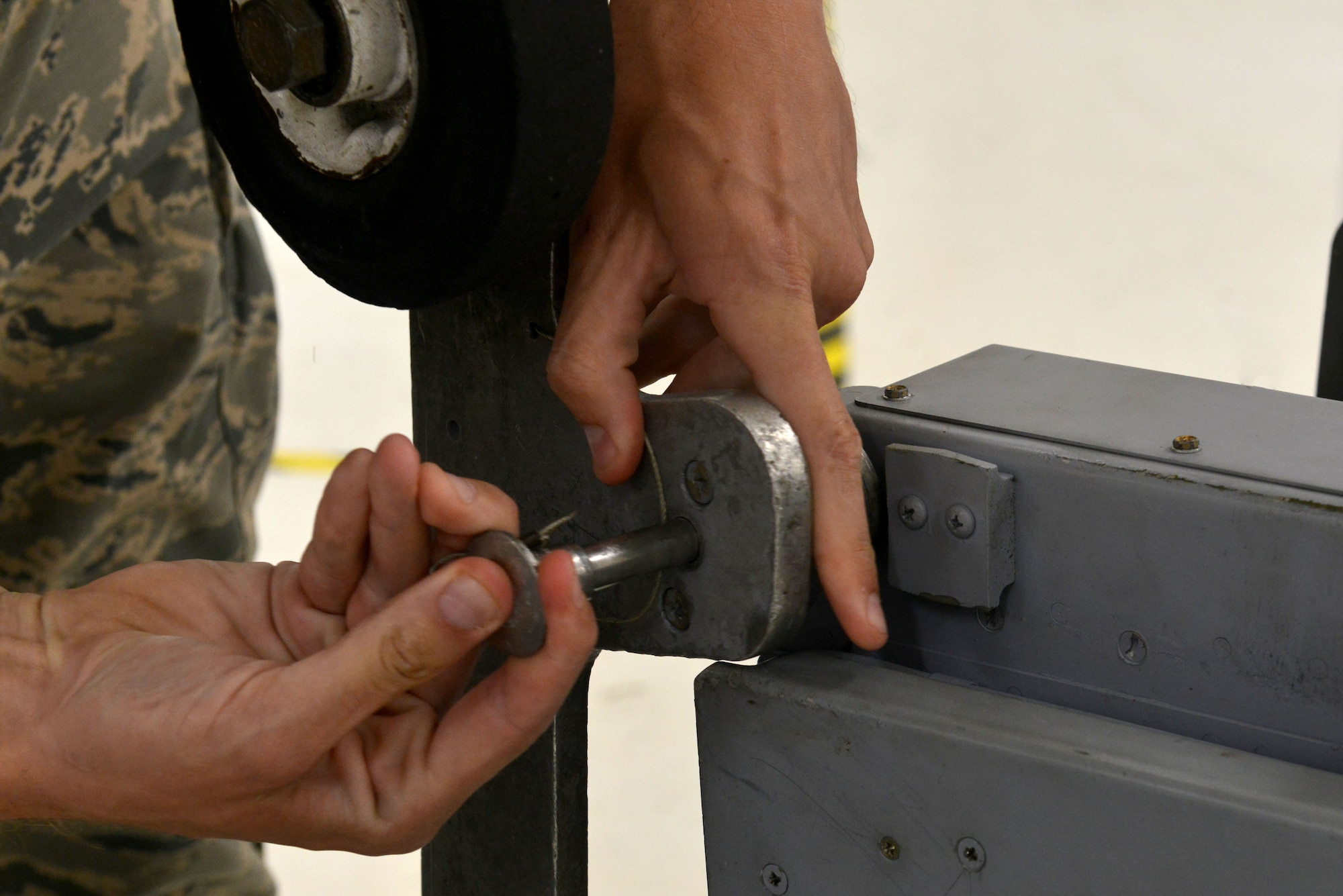 U.S. Air Force Airman 1st Class Jeremy Gibbons, 20th Component Maintenance Squadron egress apprentice inserts a pin into an aircraft seat in preparation for an inspection at Shaw Air Force Base, S.C., Sept. 26, 2016. Egress Airmen perform inspections on the rails, canopy and seat of an F-16CM Fighting Falcon every 30 days, in addition to removing foreign object debris from the cockpit and switching out ejection explosives when they expire. (U.S. Air Force photo by Airman 1st Class Destinee Sweeney)