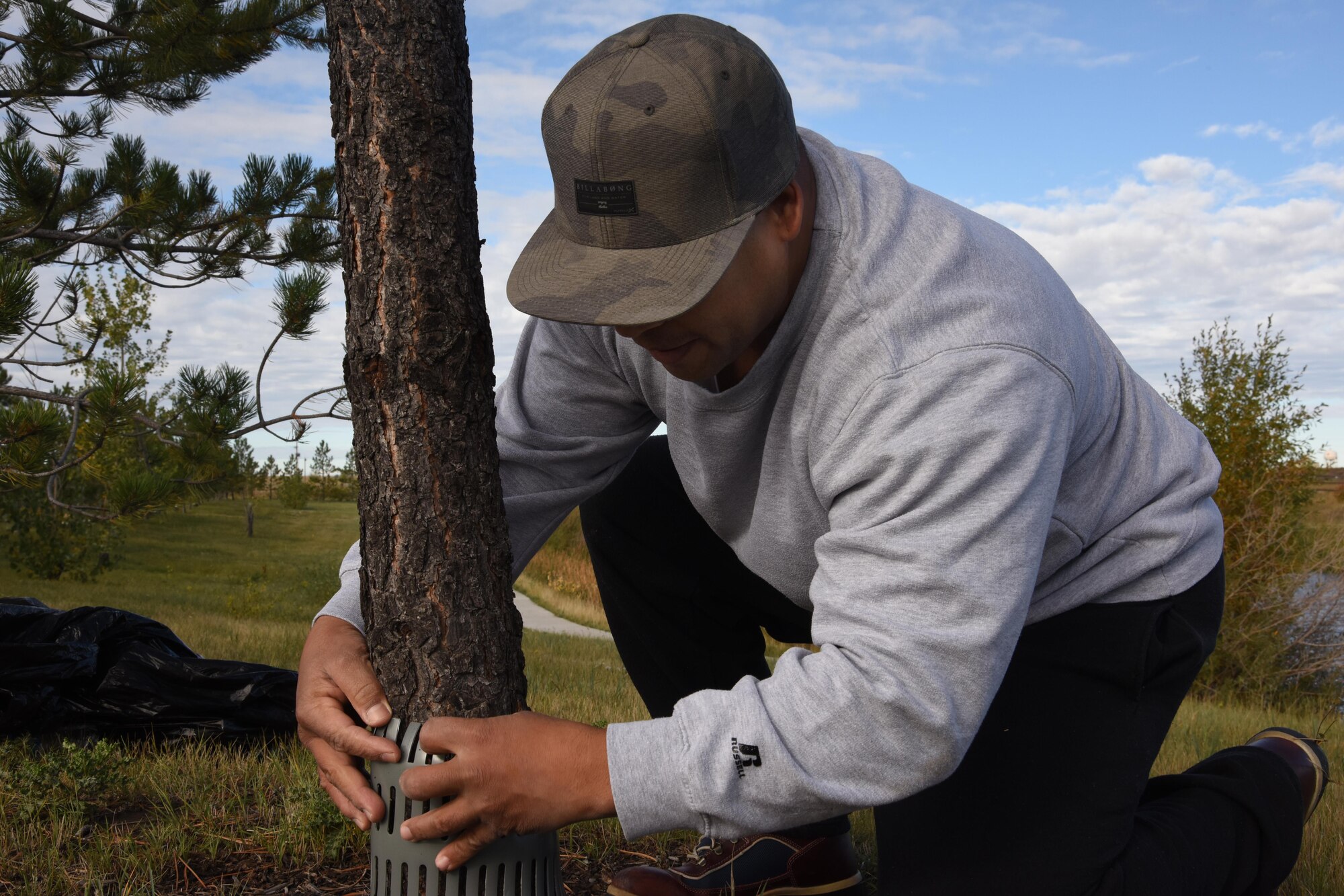 Master Sgt. Jose Lopez, 341st Missile Wing administration functional area manager, puts a tree guard around a tree during National Public Lands Day Sept. 24, 2016, at Malmstrom Air Force Base, Mont. NPLD is the nation’s second largest, single-day volunteer effort for public lands, and occurs annually on the last Saturday in September. (U.S. Air Force photo/Senior Airman Jaeda Tookes)

